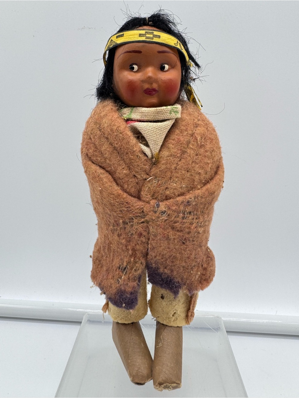 Vintage Skookum Native American souvenir doll featuring a painted face with clas
